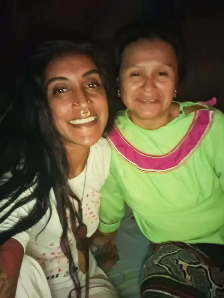 Natasha smiling with a woman from the local community.